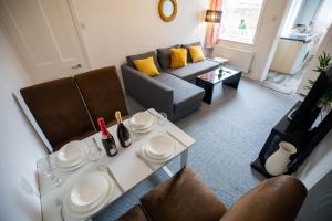 a living room with a table and a couch at Sterling Aparment in Wallsend