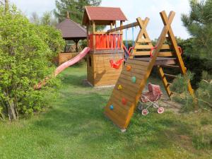 a playground with a slide and a play structure at Chata pod strzechą -Bory Tucholskie in Świekatowo