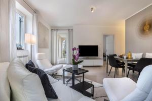 ein Wohnzimmer mit einem weißen Sofa und einem Tisch in der Unterkunft Residence La Villa Nobile in Tignale