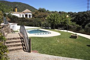 un patio trasero con piscina y una casa en San Francisco Javier en Córdoba