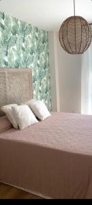 a bedroom with a bed with a pink comforter at Cordoba Luxury Home in Córdoba