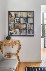 a living room with a table and a picture on the wall at Gulbenkian Apartment in Lisbon