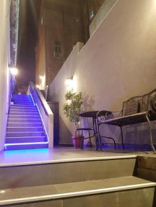 a set of stairs in a building with blue lights at Johnny Hotel in Jerusalem
