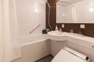 a bathroom with a sink and a toilet and a tub at SOTETSU GRAND FRESA TAKADANOBABA in Tokyo
