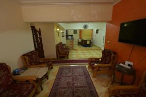 a living room with a flat screen tv and furniture at Aisling in Cairo