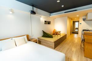 1 dormitorio con cama, mesa y escritorio en Minn Shin-Osaka en Osaka