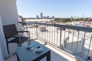 a balcony with a table and chairs on a balcony at Lazz By Ketenci Hotel in İzmir