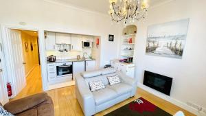 a living room with a couch and a kitchen at 2 Dartview - Close to the Water, River Views, Ground Floor Access in Dartmouth