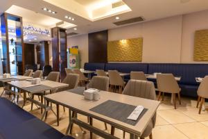 a dining room with tables and chairs at Lazz By Ketenci Hotel in İzmir