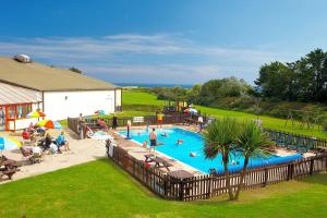 a large swimming pool with people playing in it at Sea Wagon Caravan in Brixham