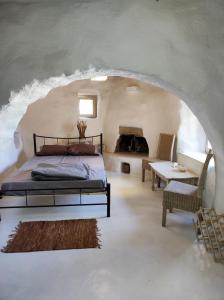 a bedroom with a bed and a couch and a table at Artemis Studio Pyrgi in Mýkonos City