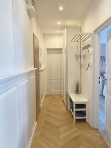 a hallway with a walk in shower and a table at Three Rings Apartments in Karlovy Vary