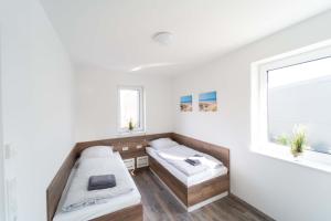 Postel nebo postele na pokoji v ubytování Ferienhaus Seebrise am Harkebrügger See mit Sauna und Kamin