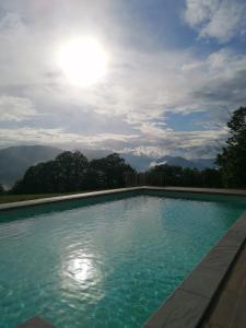 a swimming pool with a view of the mountains at Agriturismo Il Serrino in San Marcello Pistoiese