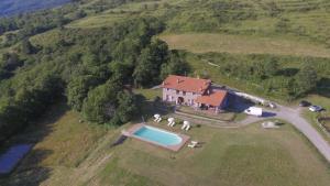 an aerial view of a house on a hill with a pool at Agriturismo Il Serrino in San Marcello Pistoiese