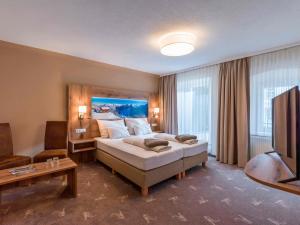 Postelja oz. postelje v sobi nastanitve SCOL Sporthotel Zillertal