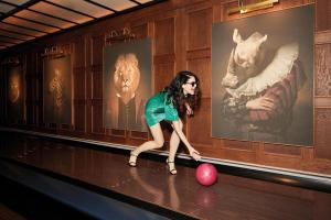 a woman in a bowling alley with a ball at BLESS Hotel Madrid - The Leading Hotels of the World in Madrid