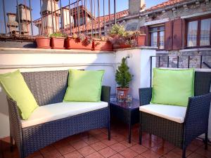 two chairs and a table on a balcony at ROOFTOP TERRACE Domus dei fabbri in Venice