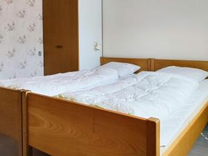 an unmade bed with white sheets on it in a room at 6 person holiday home in Højby-By Traum in Højby