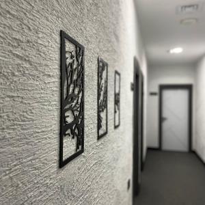 a hallway with several framed pictures on a wall at Melanj Airport Hotel in Arnavutköy