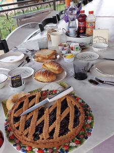 a table with a pie and pastries on it at B&B Ferro di Cavallo in Tivoli