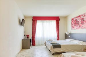 a hotel room with two beds and a window at Hotel Lumin in Cremia +41 photos
