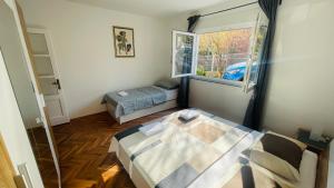 a small bedroom with a bed and a window at Apartment Iva in Rijeka