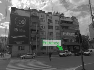 a large building with a sign that reads entrance at Elite Space in Niš