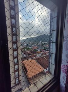 a window with a view of a city at Apartamento vista pro Mar in Praia Grande