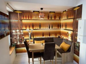 a dining room with a wooden wall with wine bottles at L'ETERNEL in Longeville-lès-Metz