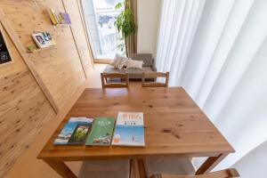 a wooden table with books on it in a room at million pointz in Amami