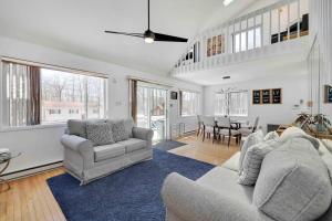 a living room with two couches and a dining room at Cozy Poconos Mountain House with 3 bedrooms in Tobyhanna