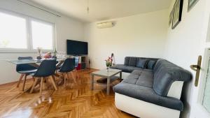 a living room with a couch and a table at Apartment Iva in Rijeka
