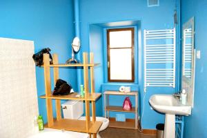 a blue bathroom with a toilet and a sink at Maison de 5 chambres avec vue sur le lac jardin clos et wifi a Menet in Menet