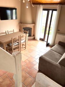 a living room with a wooden table and a fireplace at Ai house boutique in Castel di Sangro