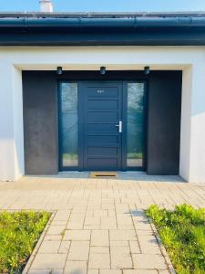 a blue door on a building with a brick patio at Villa007 in Zamárdi