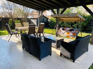 a patio with chairs and a table and an umbrella at Villa007 in Zamárdi