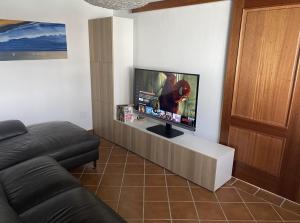 a living room with a flat screen tv on a wall at Stunning Villa Arabella - Heated Pool - BBQ - Amazing Terrace - Playa Blanca in Playa Blanca