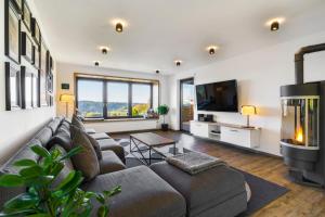 a living room with a couch and a tv at Place 4you in Grafenau