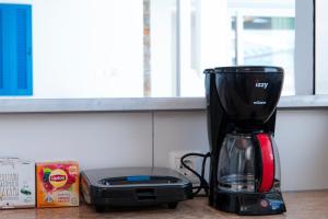 a blender sitting on a counter next to a box at Blue Waves View in Batsi