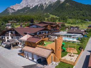 an aerial view of a resort with a playground at Hotel Tirolerhof - Familotel Zugspitze in Ehrwald