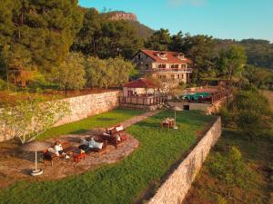 an aerial view of a house with people sitting on a lawn at Faralia Hotel in Faralya