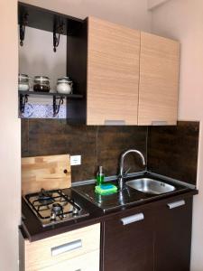 a kitchen with a sink and a stove at Taormina Center Private Apartments By Fragranza Di Sicilia in Taormina