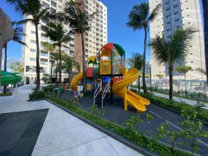 a playground in a park with a slide at Smart Salinas Premium Resort in Salinópolis