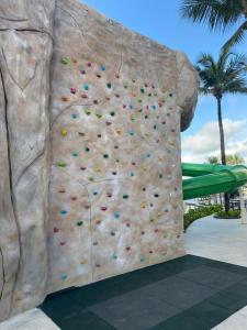 a rock wall at a resort with a climbing wall at Smart Salinas Premium Resort in Salinópolis