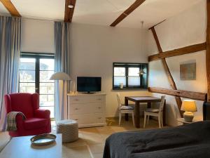 a bedroom with a bed and a desk with a tv at Gut Alt Farpen Ferienwohnung 2 in Blowatz