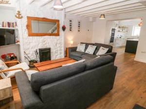 a living room with two couches and a fireplace at Gerallt in Pwllheli