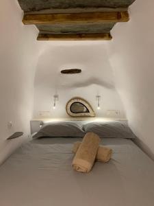 a bedroom with a bed with a towel on it at Serenity Living Platia, Tinos in Platiá