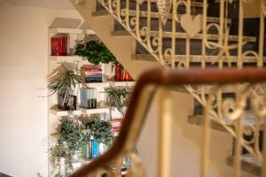 a staircase with plants and books in a room at Hotel Tigullio in Lavagna