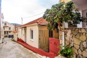 a street with a building with a red door at Christina's House in Argostoli